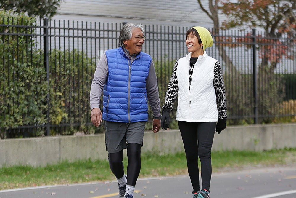 Asian American couple walking down street