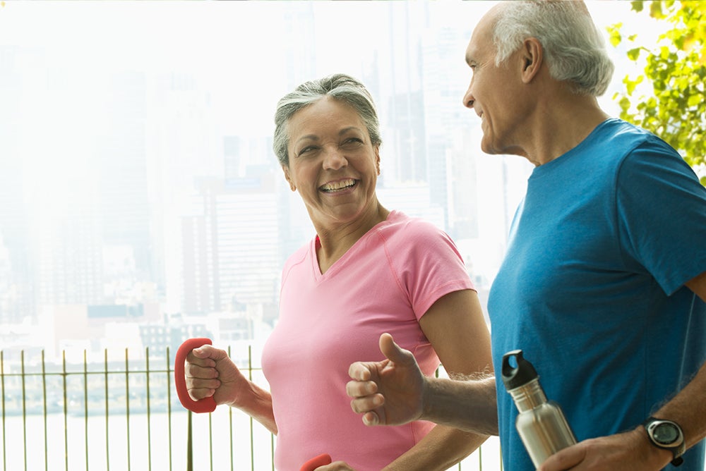 Couple walking down street with weights working out