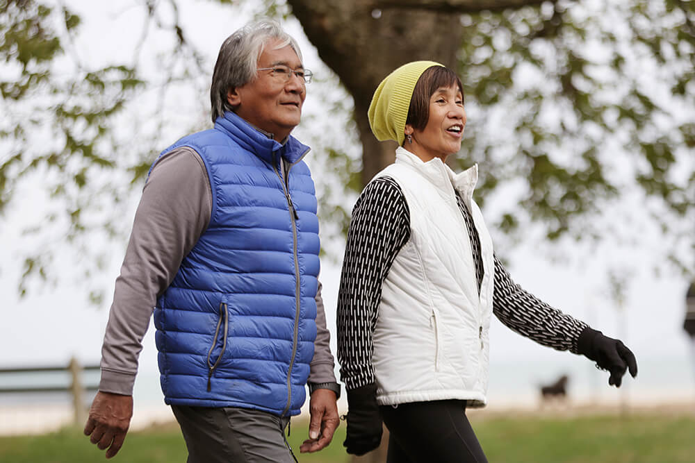 Asian American couple walking down street